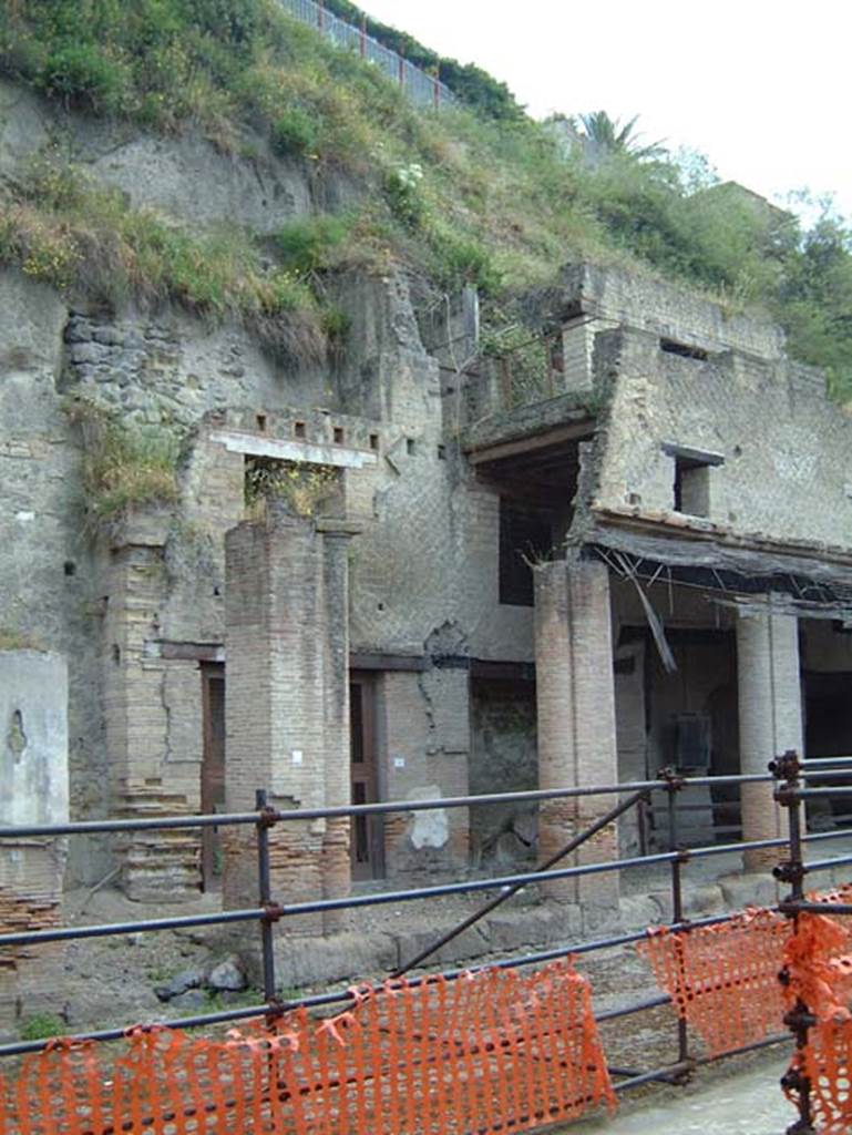 Decumanus Maximus, Herculaneum, May 2001.  Looking towards north side with doorway numbered 1, in centre behind pillar, and portico.  Photo courtesy of Current Archaeology.
