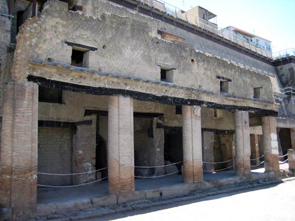 Decumanus Maximus, Herculaneum. June 2011. North side, with doorways set under portico, and windows above.
Photo courtesy of Sera Baker.
