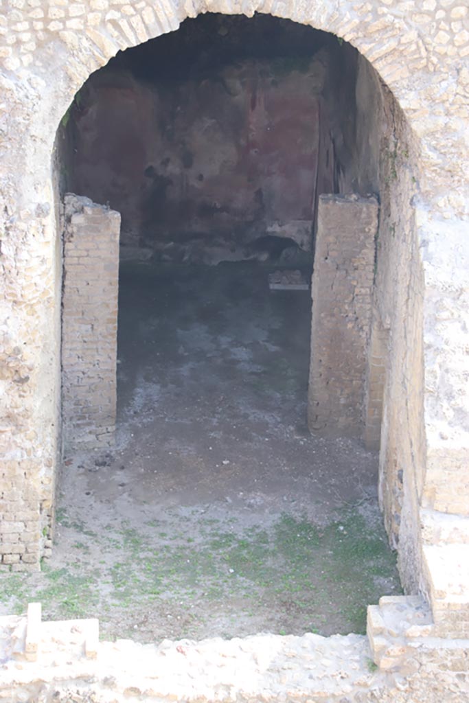 III.1/2/18/19, Herculaneum. October 2023. 
Looking north from access roadway towards room E, with room D at its rear.
Photo courtesy of Klaus Heese.
