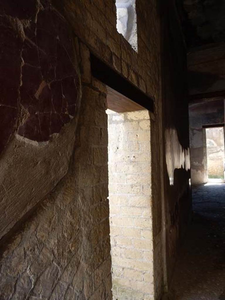 III.16, Herculaneum, May 2018. Looking east along north wall of corridor 6. 
The doorway to room 7 is in the centre. Photo courtesy of Buzz Ferebee
