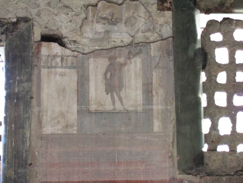 IV.4 Herculaneum. May 2006. Room 19, detail of painting between two windows from west wall of biclinium.