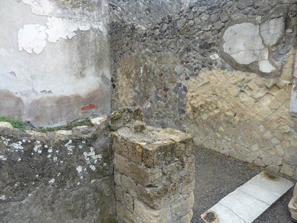 Ins. IV.8, Herculaneum, September 2015. Remains of east wall of courtyard, on left, and doorway from corridor into room at eastern end, on right.