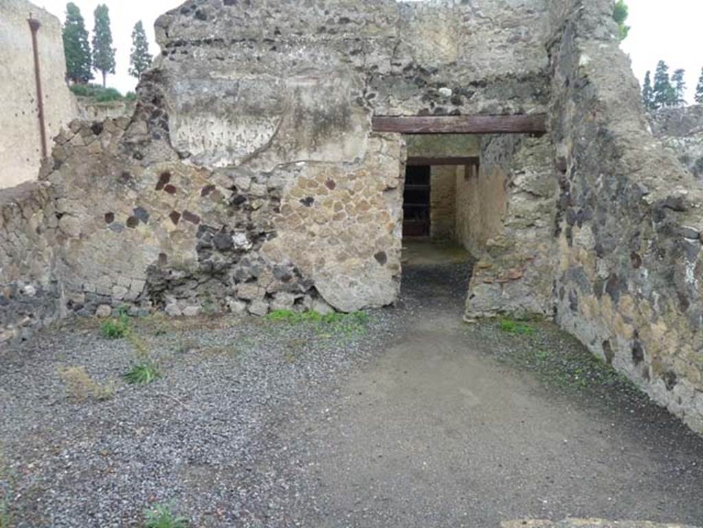 IV.10/11, Herculaneum, September 2015. Looking east across large room on east side of shop-room, probably part of IV.11.
