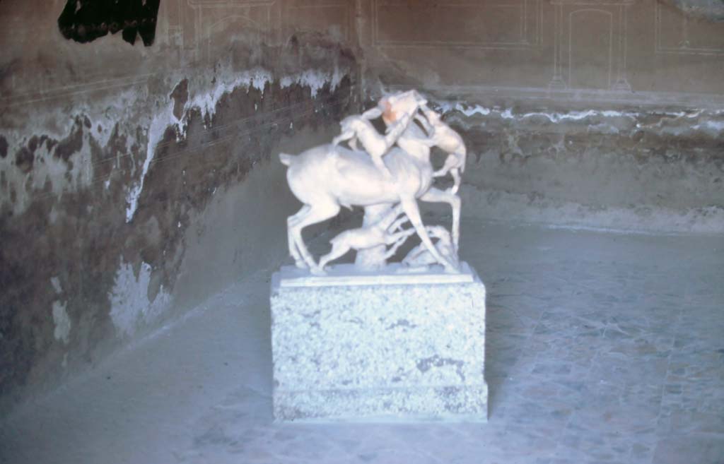 IV.21, Herculaneum. 7th August 1976. Second statue of deer being attacked by hounds, on display in a room of the house.
Photo courtesy of Rick Bauer, from Dr George Fay’s slides collection.



