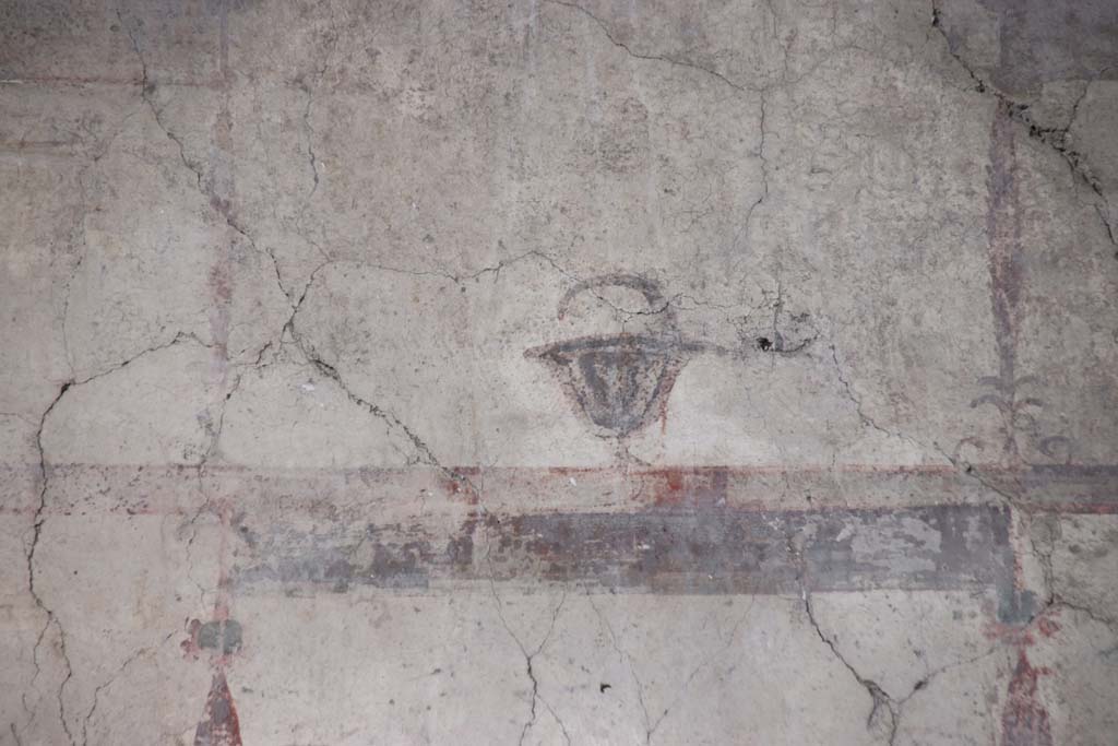 IV.21, Herculaneum. October 2020. 
Room 24, detail of painted decoration from upper west wall above doorway to room 5, in atrium. Photo courtesy of Klaus Heese.

