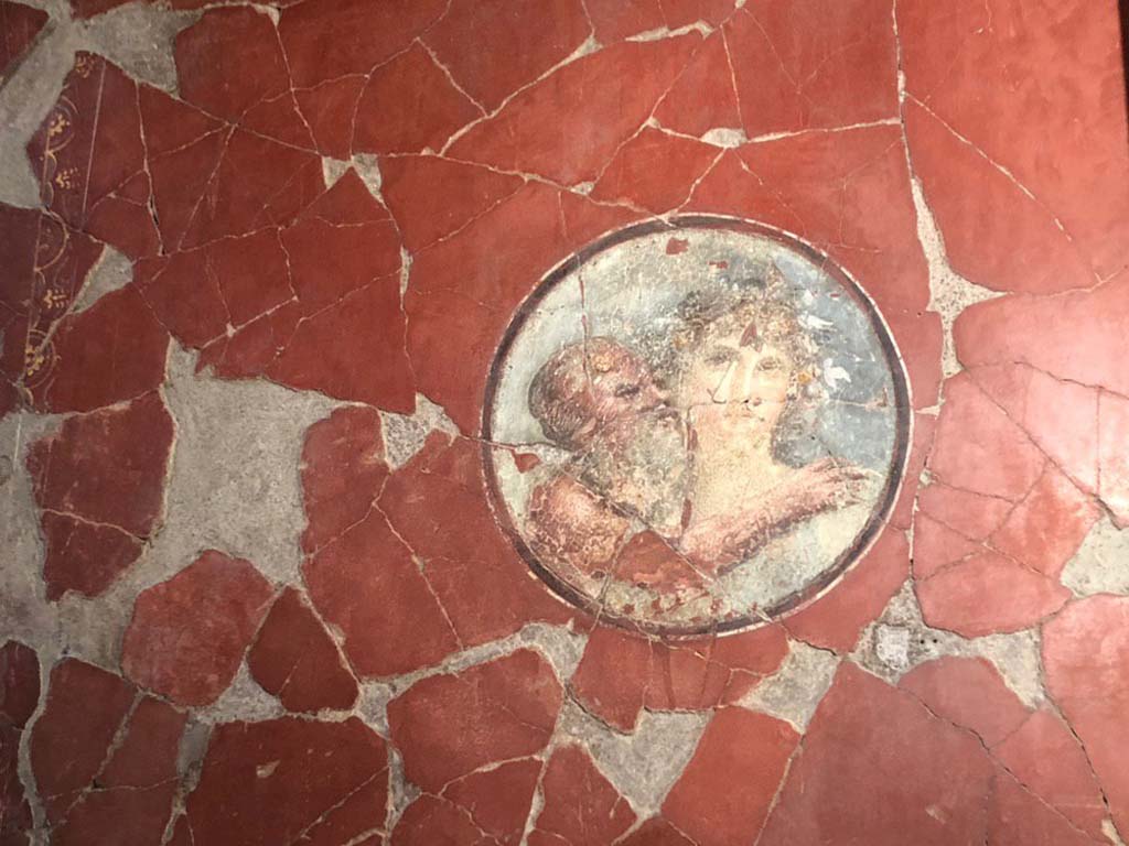 V.15 Herculaneum. October 2019. East wall of tablinum at north end, medallion with painting of an old Silenus and Maenad.
Photograph  Parco Archeologico di Pompei.
