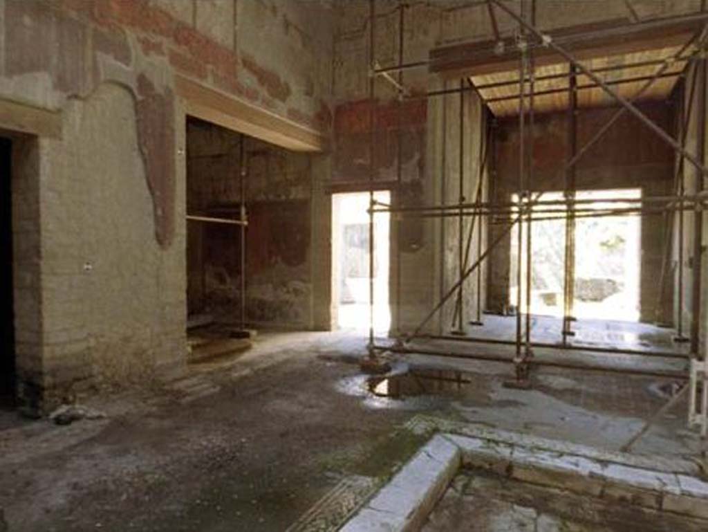 V.15 Herculaneum. Looking towards south-east corner of atrium with doorway to triclinium, and entrance to tablinum, on right.