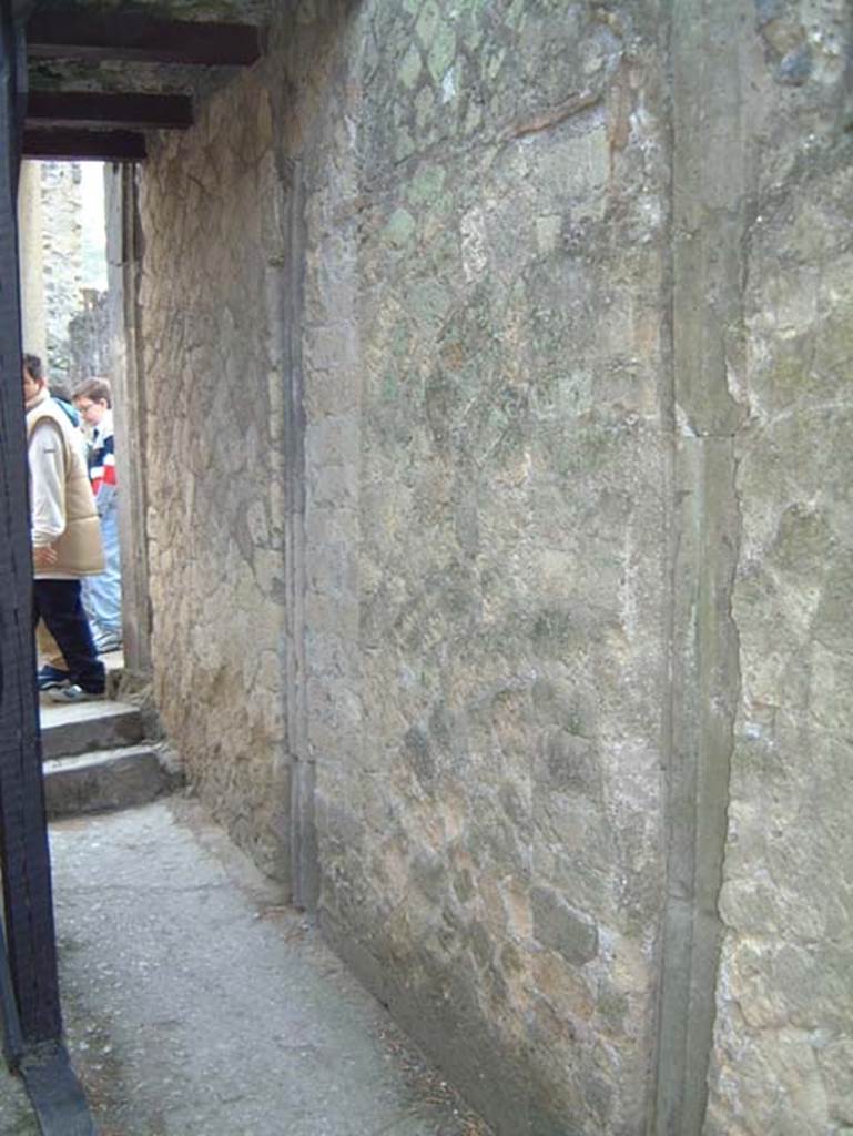 V.35, Herculaneum, May 2001. Embedded tufa columns in east wall of entrance corridor, or fauces 13.  Photo courtesy of Current Archaeology.
