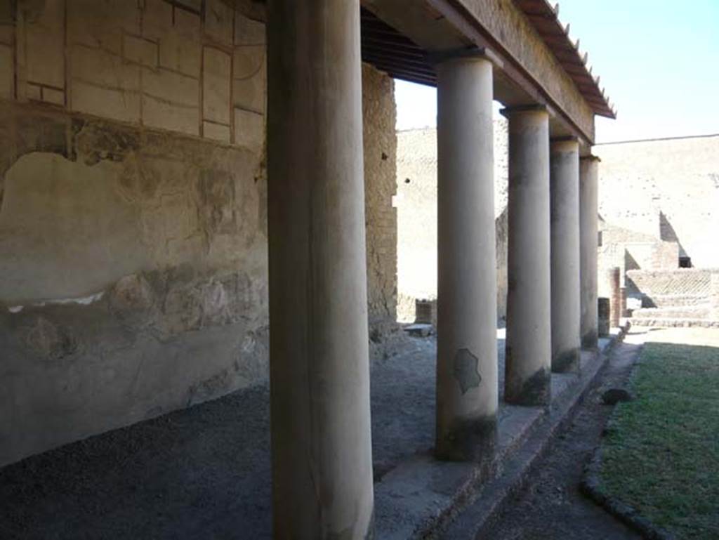 VI.1/7, Herculaneum. August 2013. Looking south along east wall of east portico, towards entrance at Ins. VI.7. Photo courtesy of Buzz Ferebee.
