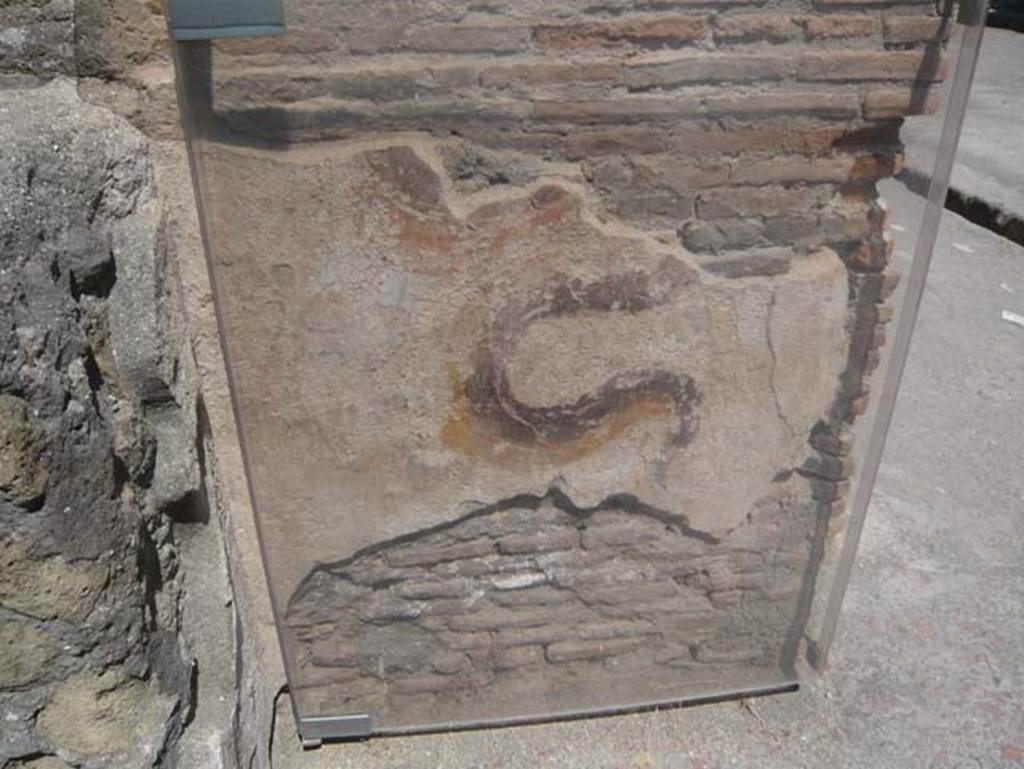 VI 12, Herculaneum, August 2013. Remains of painted serpent on street shrine on north-east corner of Insula VI, adjacent to the shop at VI.12. Looking west. Photo courtesy of Buzz Ferebee.  See also Ins. V.9.


