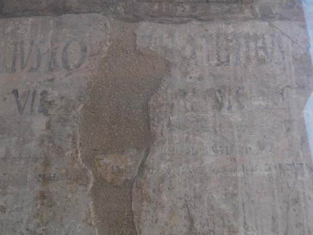 VI 12, Herculaneum, August 2013. Detail of graffiti on north-east corner of Insula VI, adjacent to the shop at VI.12.  Photo courtesy of Buzz Ferebee.  
