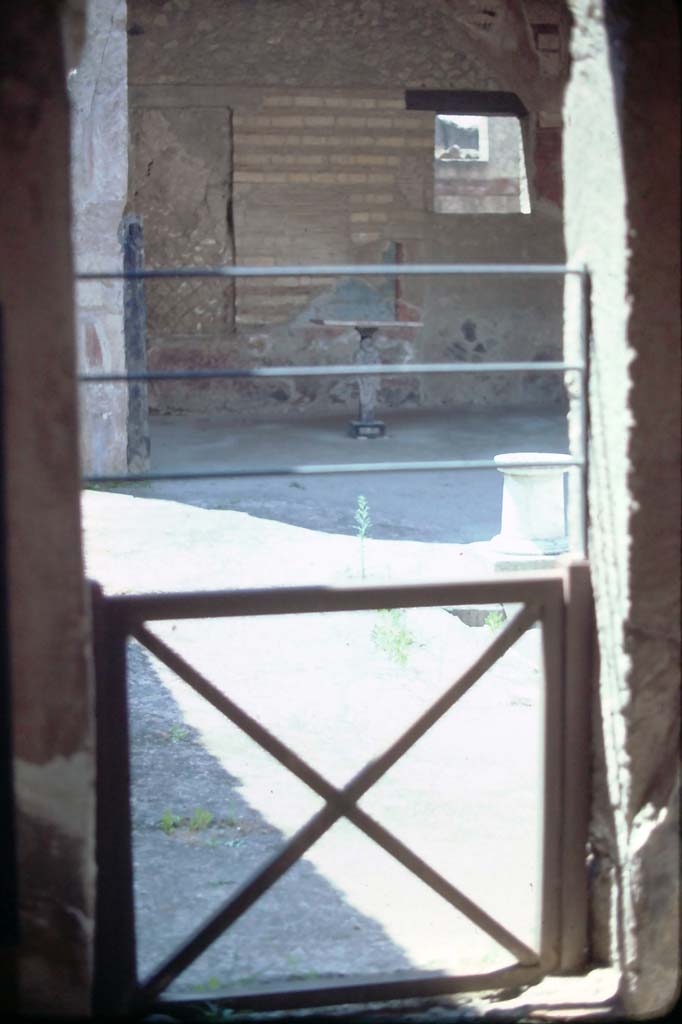 VI.16 Herculaneum. 7th August 1976. 
Looking through doorway in south-west corner, linking to atrium of VI.17.
Photo courtesy of Rick Bauer, from Dr George Fay’s slides collection.
