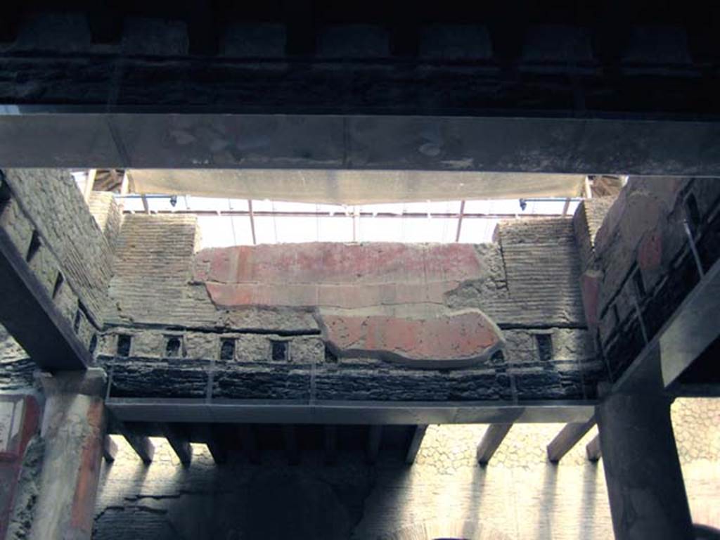 VI.21 Herculaneum. June 2011. Looking west towards area with reconstructed modern floor beams of upper floor.
Photo courtesy of Sera Baker.
