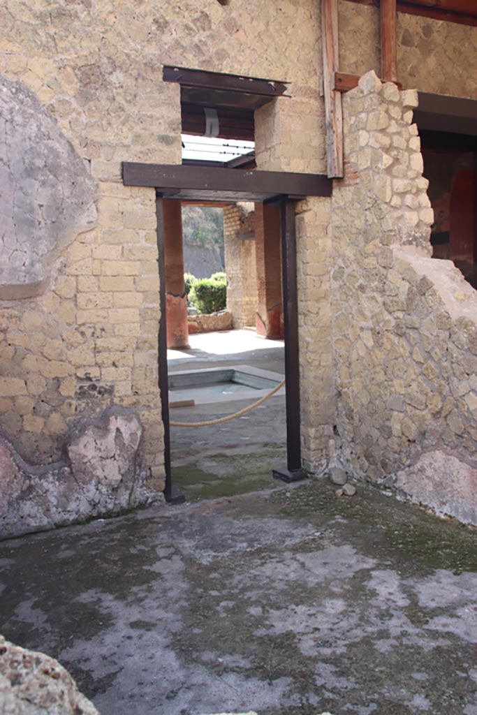 Ins. Orientalis I, 1, Herculaneum, October 2023. 
Looking south-east across room on north side of entrance doorway towards doorway into atrium.
Photo courtesy of Klaus Heese.
