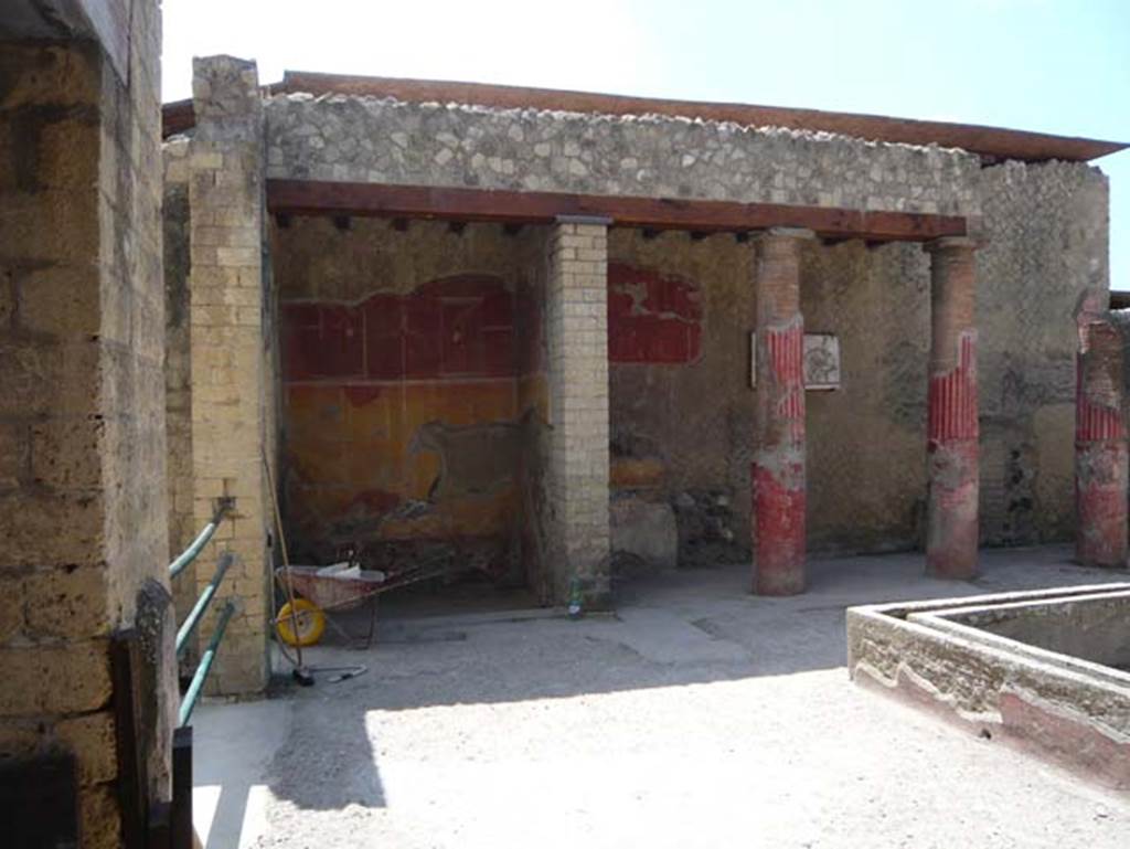 Ins. Or.I.2, Herculaneum. August 2013. Looking south across atrium, from near corridor leading from rear garden towards the south-east corner (with wheelbarrow).
Photo courtesy of Buzz Ferebee.  

