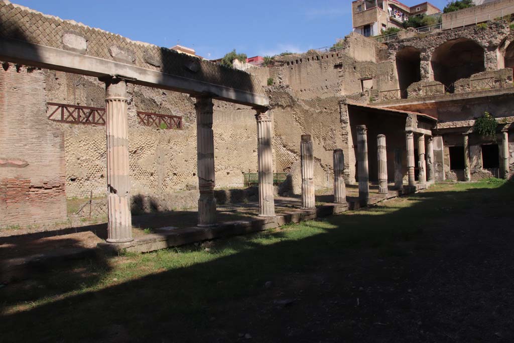Ins. Orientalis II.4, Herculaneum, September 2019.  
Looking north-west from exit doorway of the unexcavated palaestra, along the west portico. 
Photo courtesy of Klaus Heese.
