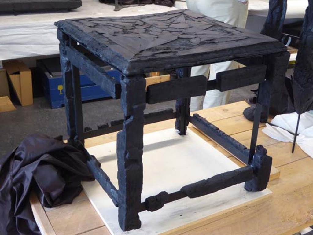 Ins. Orientalis II.10, Herculaneum. September 2016. Small wooden stool/table with inlaid top. 
Photo courtesy of Michael Binns.
This table has also been entered into the pages for VI.29 (pt 4, including other sides of the stool/table), as there is some confusion as to its provenance/location where found.
See De Carolis, E. (2007). Il mobile a Pompei ed Ercolano: letti tavoli sedie e armadi. Rome, “L’ERMA” di Bretschneider, (p.125, fig.88).
According to Wallace-Hadrill, “the wooden stool was from the house opposite” (opposite to Ins.Or.II.10). 
See Wallace-Hadrill, A. (2011). Herculaneum, Past and Future. London, Frances Lincoln Ltd., (p.278).
A photo of the room prepared by Maiuri, taken in 1957, shows the top of the stool/table.
See Camardo, D. & Notomista,M. (2017). Ercolano: 1927-1961. Rome, “L’ERMA” de Bretschneider, (Scheda 50, p.273-274).

