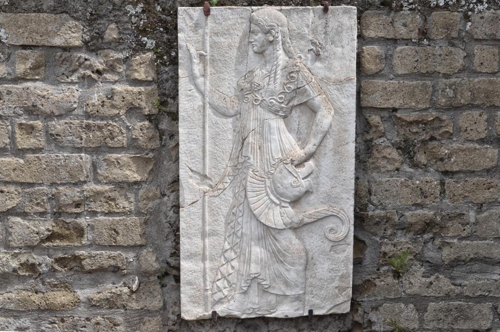 Herculaneum, April 2018. Reproduction relief of Minerva from the shrine of Four Gods on the Sacred Area terrace. 
Photo courtesy of Ian Lycett-King. Use is subject to Creative Commons Attribution-NonCommercial License v.4 International.
