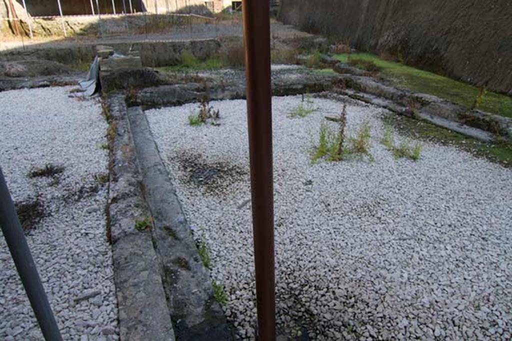 Villa dei Papiri, Herculaneum. July 2010. 
Looking east along the large pool parallel to the coastline, towards the area of the small room with stairs and ramp providing access to the beach approximately six metres below.  Photo courtesy of Michael Binns.


