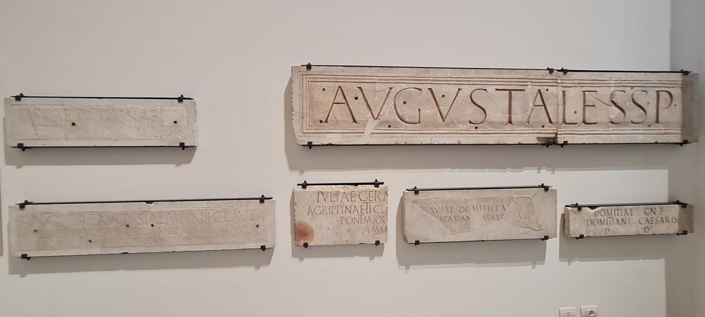 Herculaneum Augusteum. April 2023. Display of marble slabs with Dedications. Photo courtesy of Giuseppe Ciaramella.