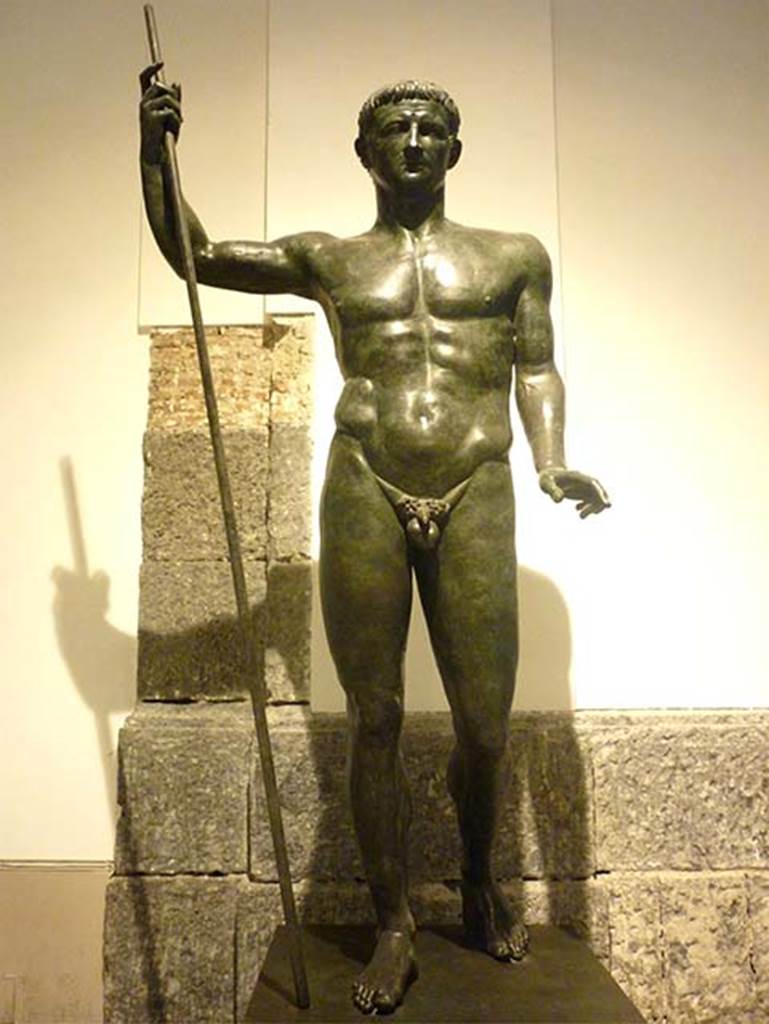 Herculaneum Augusteum. Found 20.12.1741 in front of right apse. Bronze statue of Claudius as a heroic nude. 
Now in Naples Archaeological Museum. Inventory number 5593.


