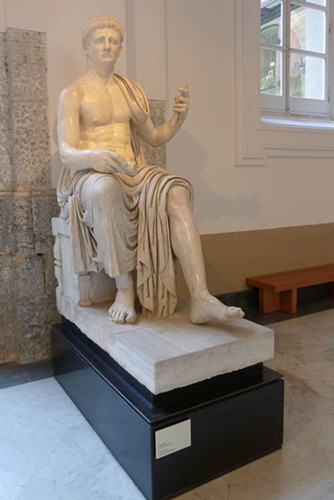 Herculaneum Augusteum. Square exedra. Statue of a seated Claudius. 
Now in Naples Archaeological Museum. Inventory number 6056.

