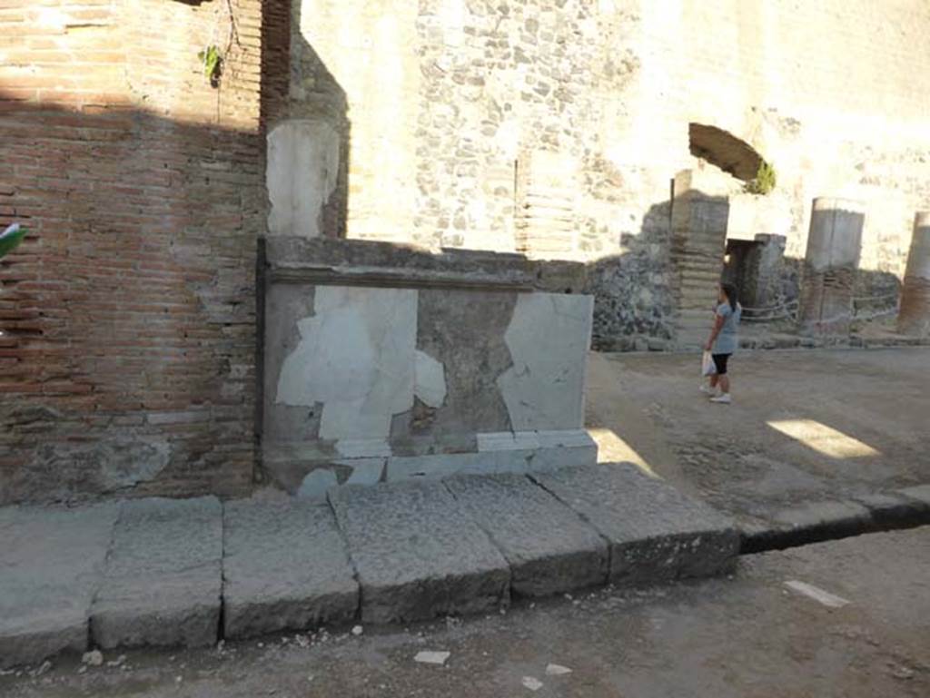 Herculaneum, September 2015. Looking north towards second statue base on east side of arch.
The entrance doorway for the photo below can be seen on the left of the photo, behind the figure.