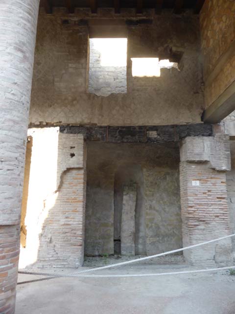 Decumanus Maximus, Herculaneum, number 8, May 2003. 
Looking towards east side of entrance doorway, and fittings for the box built with tiles. 
Photo courtesy of Nicolas Monteix.
According to Monteix, 
“Wedged, on the right, between the entrance doorway and the eastern wall, a small structure served as a support for three tiles.
The tile forming the north face is pierced by a semi-circular opening of about 30cm which would have been used as a mouth to feed the hearth.
The socket would then have served as a support for the dishes used for cooking, or even water heaters using a ceramic container.”
See Monteix, N. 2010. Les lieux de metier. Boutiques et ateliers d’Herculanum. (p.100).

Photo courtesy of Nicolas Monteix.
According to Monteix, 
“Another system, less frequently used, was employed at Herculaneum, in shop No. 8
Wedged, on the right, between the entrance doorway and the eastern wall, a small structure served as a support for three tiles.
The tile forming the north face is pierced by a semi-circular opening of about 30cm which would have been used as a mouth to feed the hearth.
The socket would then have served as a support for the dishes used for cooking, or even water heaters using a ceramic container.”
See Monteix, N. 2010. Les lieux de metier. Boutiques et ateliers d’Herculanum. (p.100)


