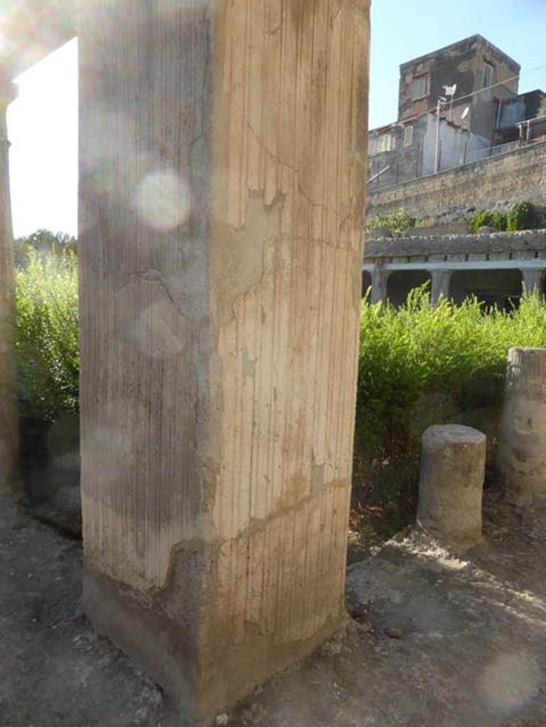 II.2 Herculaneum, September 2015. Upper stuccoed pilaster on north-east corner of peristyle.  The holes for the support beams for the floor of the upper rooms can be seen above the pilaster.  Looking west along the north portico. 

