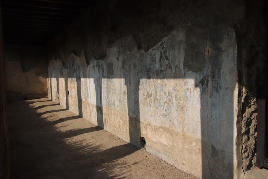 II.2 Herculaneum, October 2023. Remaining painted decoration at south end of west wall of portico. Photo courtesy of Klaus Heese.