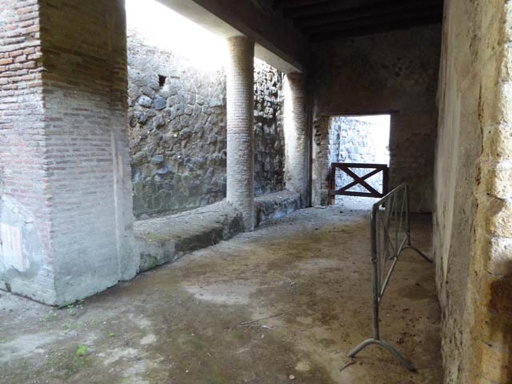 II.2 Herculaneum, October 2014. Looking towards north-west side and part of a second peristyle which has not been excavated, taken from doorway from west portico. Photo courtesy of Michael Binns.
According to Barker – “In the second peristyle the wall was divided into five panels, with borders of fine geometrical design and architectural decorations, seen in the perspective. Along the top runs a frieze of purely decorative and very light architectural design, and without any possibly organic cohesion. Along the bottom is a frieze divided, vertically, into panels, with little pictures of birds and plants.”
See Barker, E.R. (1908). Buried Herculaneum, (p.162).

