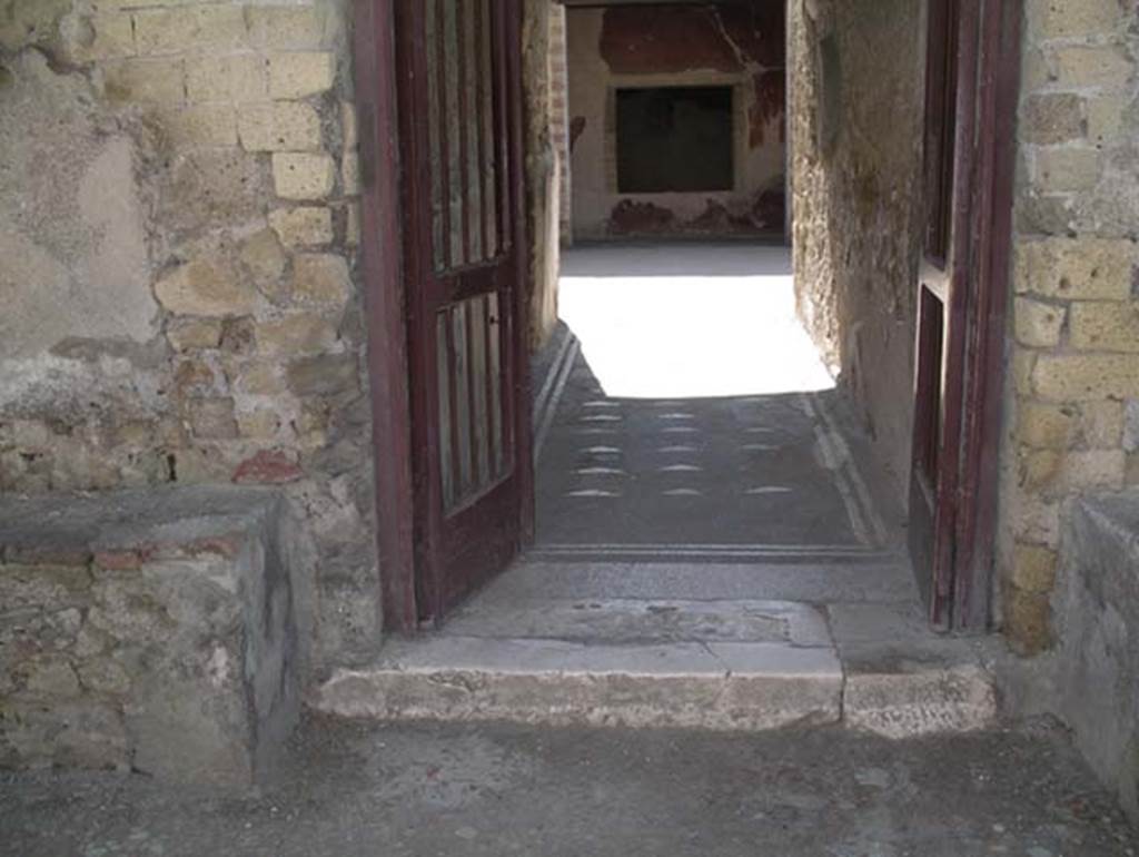 III.3, Herculaneum, May 2010. Entrance doorway, looking east on Cardo III Inferiore. 