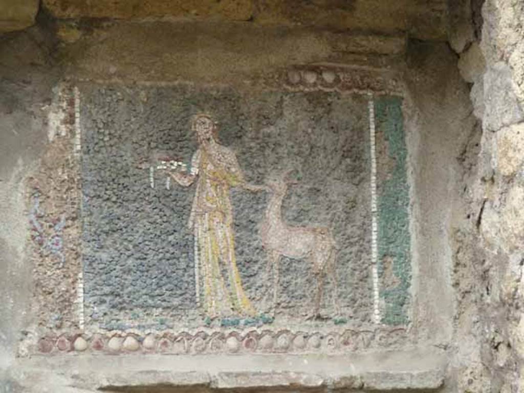 III.3 Herculaneum. May 2010. Frieze at south end, on right hand side. According to Guidobaldi and Esposito, this shows a supplicant with a fawn. On the left, but missing, would have been another mosaic, presumably similar to the second one from the northern end.  

