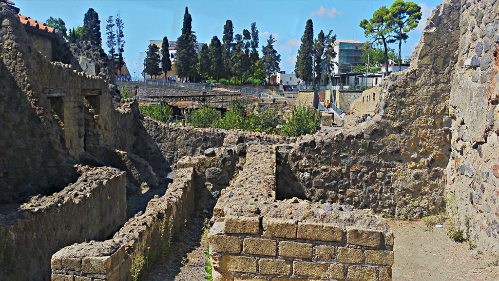 III.3 Herculaneum. Photo taken between October 2014 and November 2019. 
Rooms on the south side of atrium, with steps to upper floor, in centre. Photo courtesy of Giuseppe Ciaramella.
