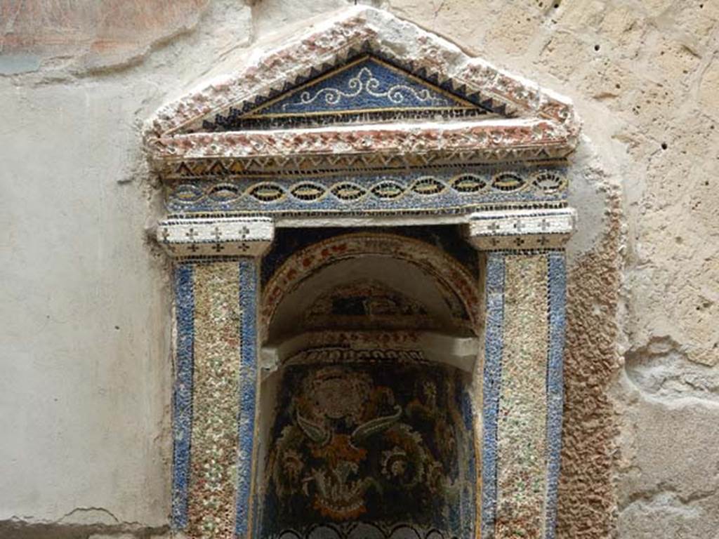 III.3 Herculaneum, May 2018. Detail of mosaic and shell-trimmed aedicula.Photo courtesy of Buzz Ferebee

