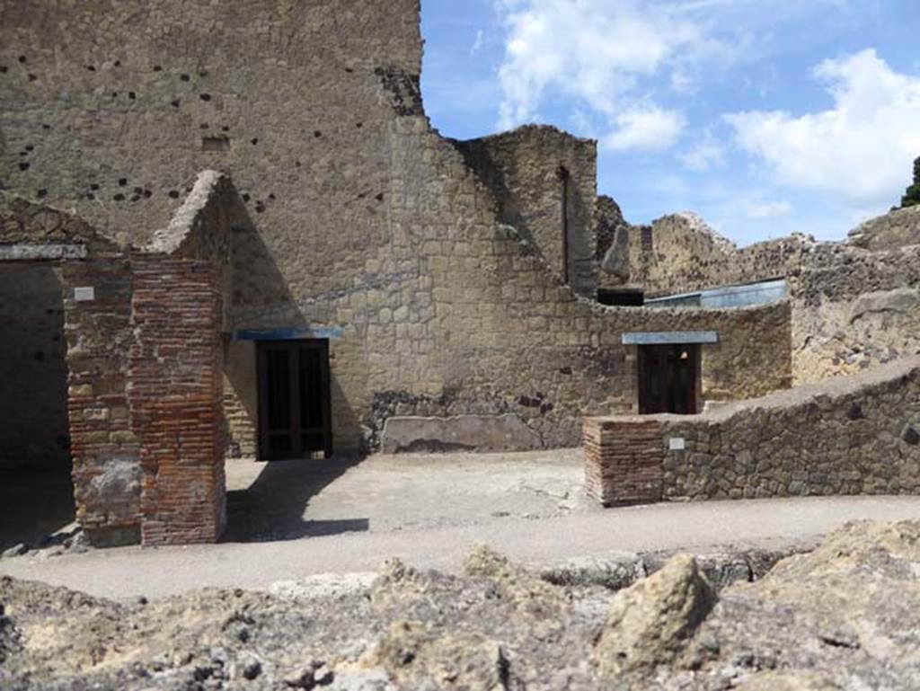 III.8 Herculaneum, July 2015. Looking south to entrance doorway to shop, with two doorways from the Casa del Tramezzo di legno in the south wall of the shop.
Photo courtesy of Michael Binns.
