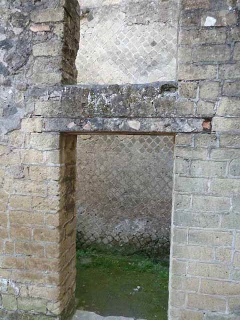 Ins. III.9. Herculaneum. May 2010. Doorway in east wall to latrine.