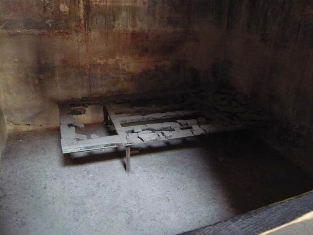 III.11 Herculaneum. May 2009. Room 5, Carbonized bed in south-west corner. Photo courtesy of Buzz Ferebee.
