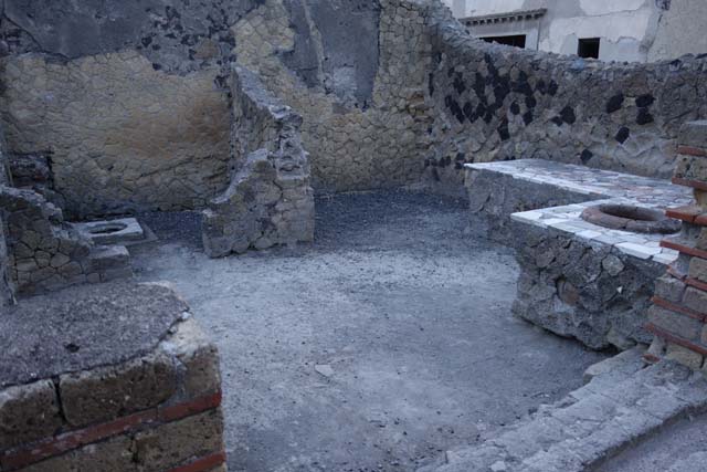 IV.10, Herculaneum, October 2014. Entrance doorway on south side of Decumanus Inferiore, looking south-west across shop.   Photo courtesy of Michael Binns.
