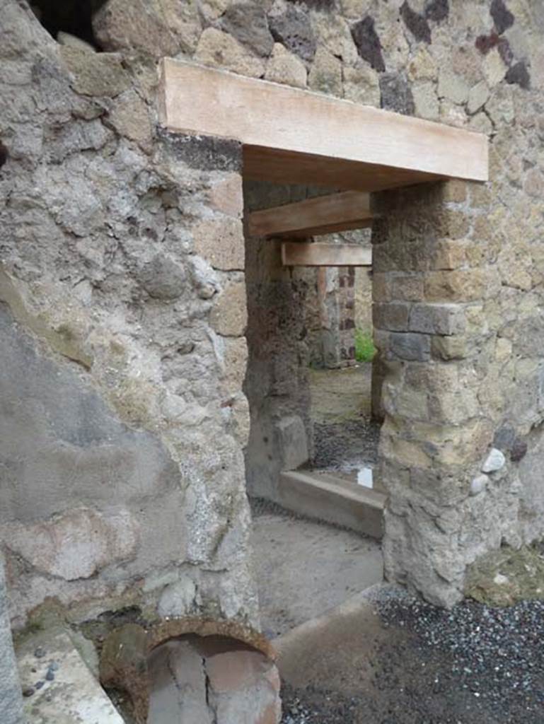IV.15/16, Herculaneum, September 2015. Doorway to rear rooms in south-west corner of shop-room. Right of centre, is a doorway leading to the dwelling part of the house.
