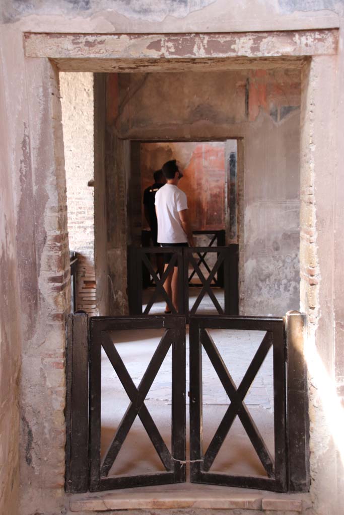 IV.21, Herculaneum, September 2019. 
Room 24, doorway on west side of atrium into triclinium 5, and through to the rooms 6 and 7, oecus.
Photo courtesy of Klaus Heese.
