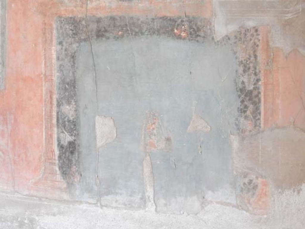 IV.21, Herculaneum. May 2018. Triclinium 5, detail of blue painted panel of masks, very badly faded, and left in situ.
Photo courtesy of Buzz Ferebee. 
