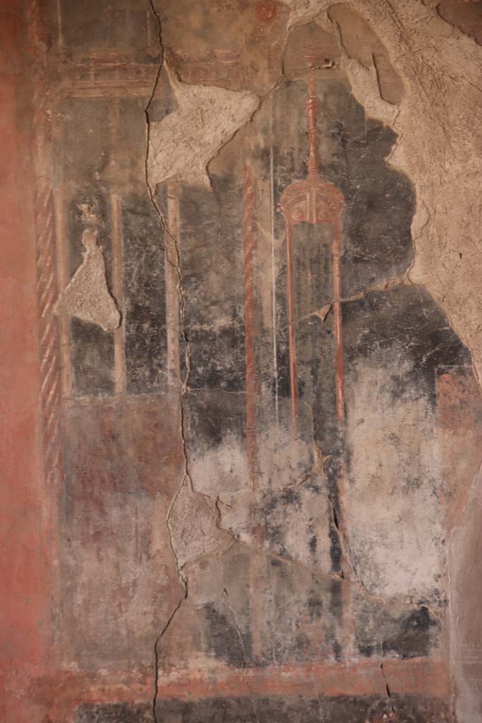IV.21, Herculaneum. October 2020. 
Triclinium 5, detail from panel on east wall at south end above blue painted panel.
Photo courtesy of Klaus Heese.
