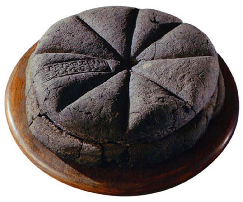 IV.21, Herculaneum. Uncut loaf of carbonised bread with stamped inscription. The loaf of bread had a stamp Property of Celer, slave of Q. Granius Verus.
See Wallace-Hadrill, A. (2011). Herculaneum, Past and Future. London, Frances Lincoln Ltd., (p.242-244).
According to Pagano and Prisciandaro on 5th October 1748, an entire loaf of carbonised bread was found, with a mark that contained these letters 
[C]eleris Q(uinti) Grani
Veri ser(vi)    - CIL X 8058,18
Now in Naples Archaeological Museum, inventory number 84596.
See Pagano, M. and Prisciandaro, R., 2006. Studio sulle provenienze degli oggetti rinvenuti negli scavi borbonici del regno di Napoli.  Naples: Nicola Longobardi. (p.205)
The footnote 163 states, see also the seal found 15th May 1755, CIL X 8058,18, belonging to Celer, slave of Q. Granius Verus.  The seal actually in the Antiquarium Comunale of Celio at Rome). 
