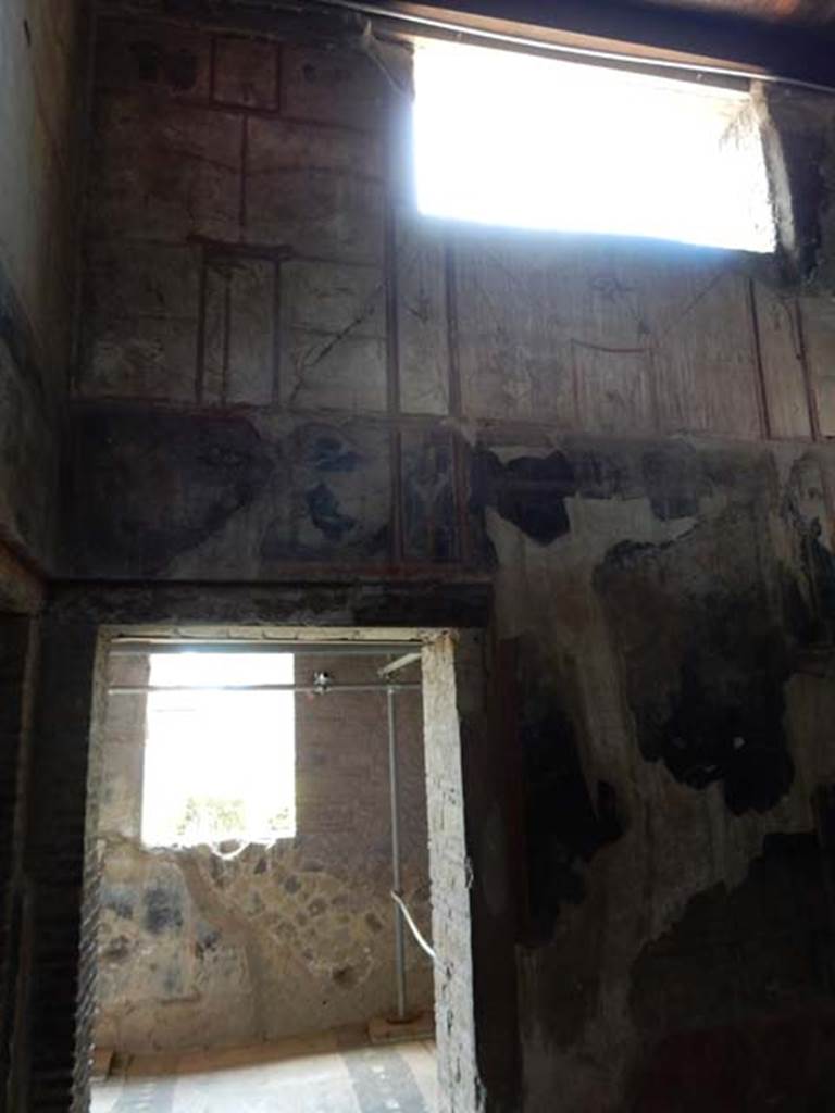 IV.21, Herculaneum. May 2018. Room 6, south wall with doorway to Cryptoporticus 28.
Photo courtesy of Buzz Ferebee. 
