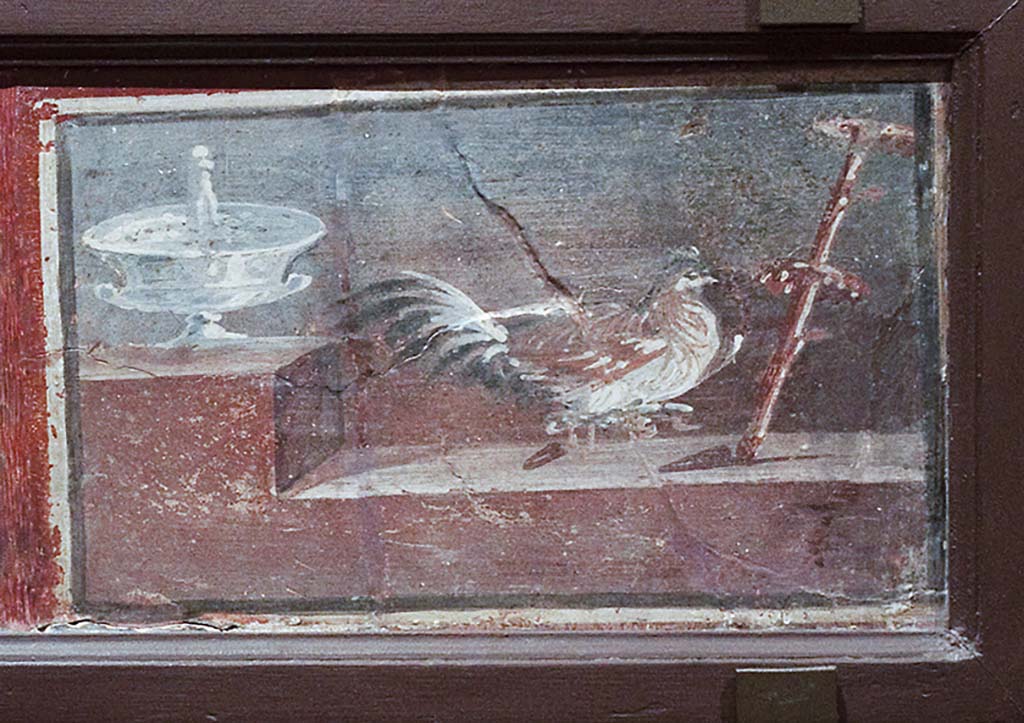 IV.21, Herculaneum? Cockerel and silver cup on a shelf. 
Now in Naples Archaeological Museum. Part of inventory number 9177.
