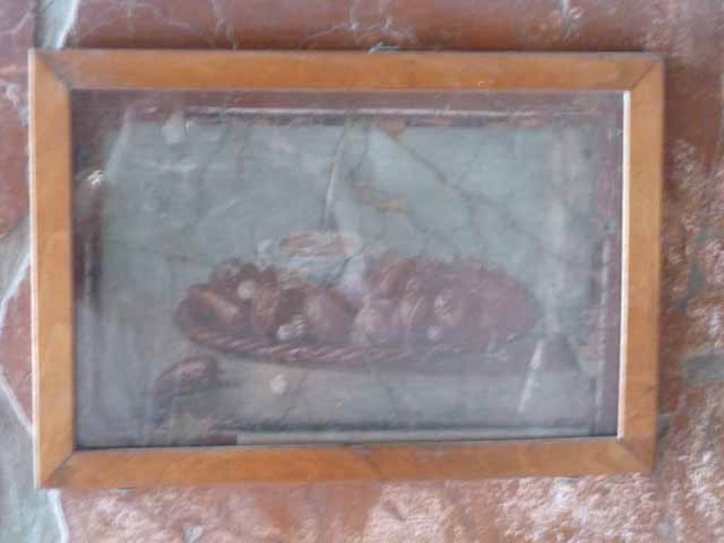 IV.21, Herculaneum.  May 2010. Eastern ambulatory of cryptoporticus 29, west wall, middle zone, small still life with fruit and nuts on a wicker tray.
