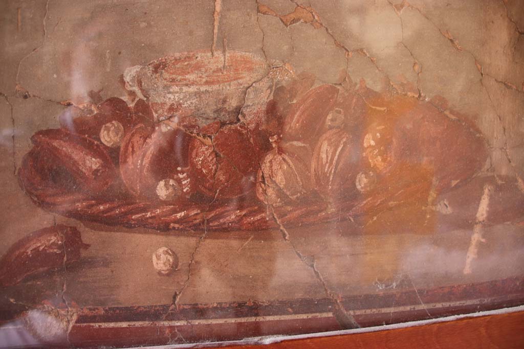 IV.21, Herculaneum. September 2019. 
Cryptoporticus 29, west wall, middle zone. Detail of small still life with fruit and nuts on a wicker tray. 
Photo courtesy of Klaus Heese. 
