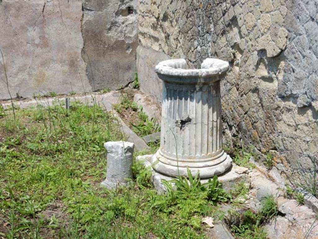 IV.21, Herculaneum. May 2018. Garden 32, fluted puteal above cistern-mouth near north wall. Photo courtesy of Buzz Ferebee. 
According to Jashemski – “A gutter at the edge of the garden carried off the roof water to the cistern.
The puteal over the mouth of the cistern near the west end of the north gutter was badly worn from the friction of the rope.”
See Jashemski, W. F., 1993. The Gardens of Pompeii, Volume II: Appendices. New York: Caratzas. (p.264)

