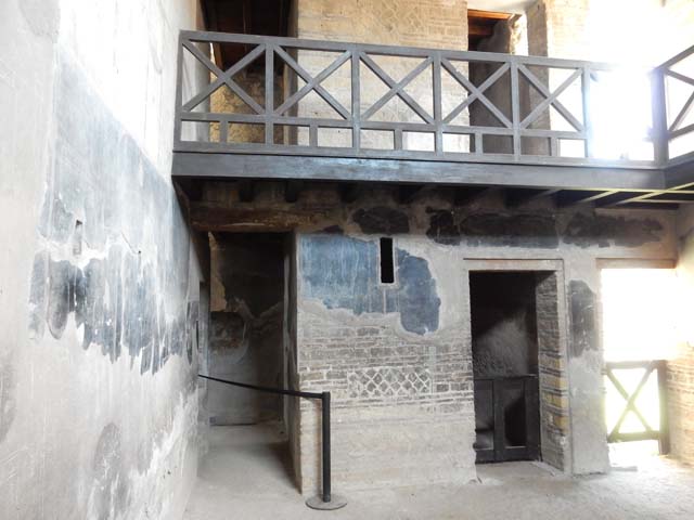 IV.21, Herculaneum. May 2018. Room 24, looking north across atrium towards corridor 25 leading to kitchen area, on left.
The doorway to room 4 is centre right. Photo courtesy of Buzz Ferebee. 

